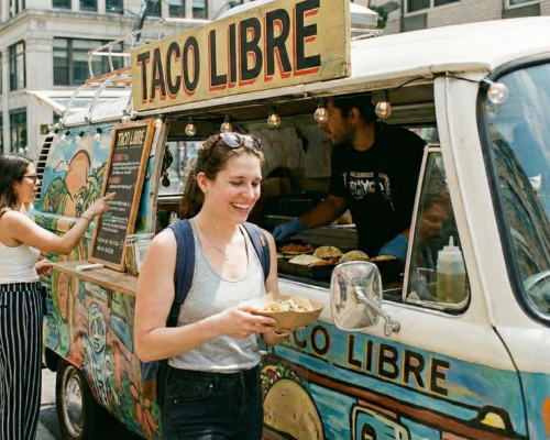 Happy customer leaving with their food truck order