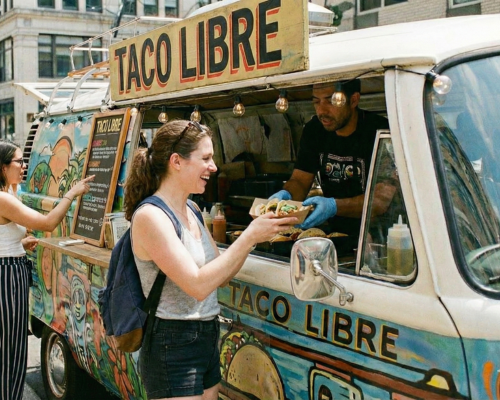 Customer picking up their food truck order