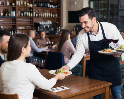 Guests paying on their phone at the table